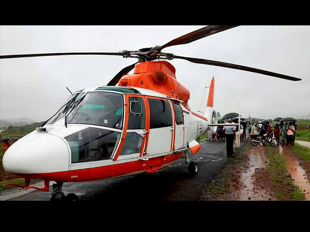 A BSF helicopter lands in Koraput on Tuesday due to inclement weather conditions on its way to Rayagada for air-dropping flood relief material in Rayagada. PTI Photo