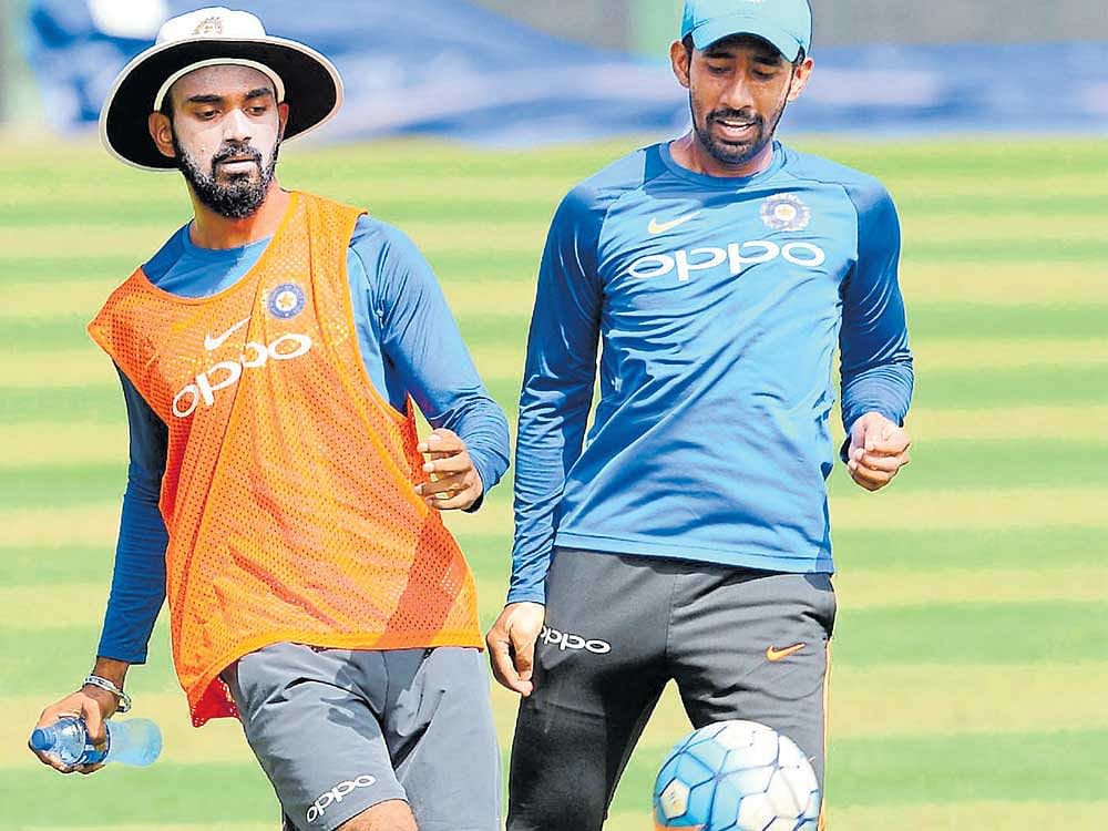 back on the field: India's K L Rahul (left) enjoys a game of football while Wriddhiman Saha looks on at the SSC in Colombo on Tuesday. AFP