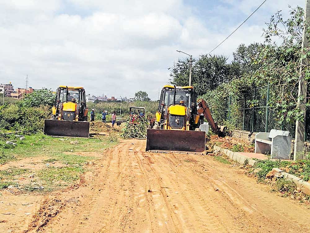 The project division of BBMP has dumped many truckloads of soil inside the Kaggadasapura lake to build the road. dh photo