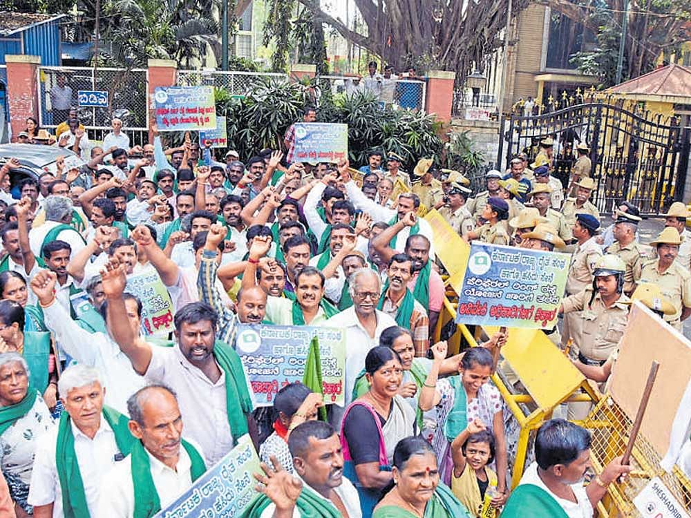 Farmers parting with their land for the Peripheral Ring Road (PRR) will be compensated under the 2013 land acquisition law. In this file picture, farmers protest the delay in  implementing the project at the BDA head office.