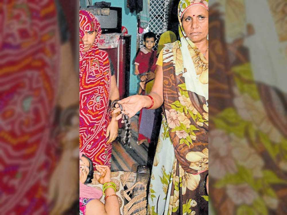 A woman displays chopped hair in Uttar Pradesh's Mathura city on Thursday. PTI