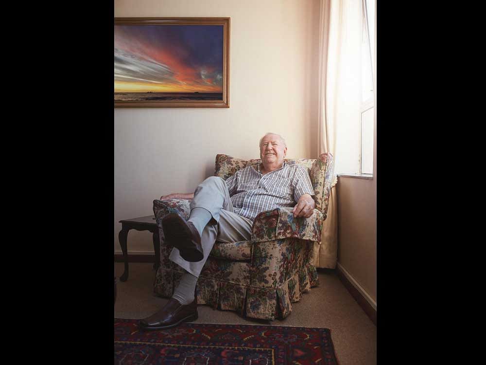 Indoor shot of old man relaxing on an arm chair at home