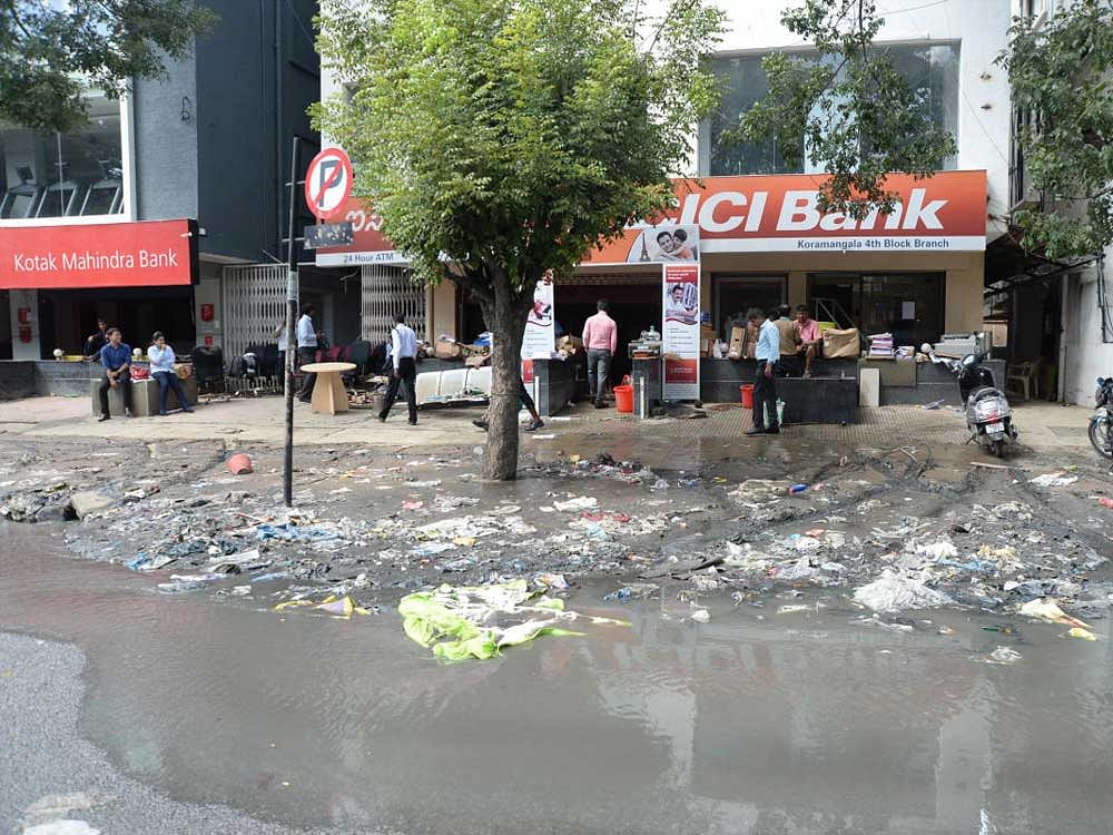 A view of drainage at Koramangala main road which is stinking due to recent rain in Bengaluru on Wednesday. Photo by Satish Badiger Close
