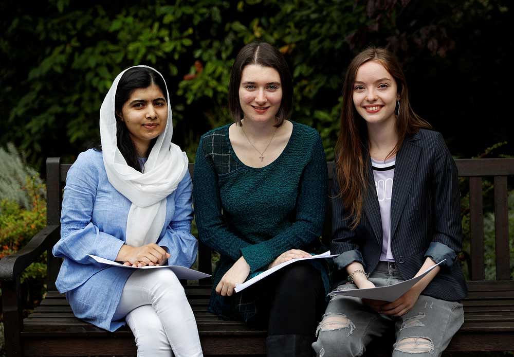 Malala Yousefzai (L) poses with fellow students Bethany Lucas (C) and Beatrice Kessedjian after collecting her 'A' level exam results. Reuters photo.