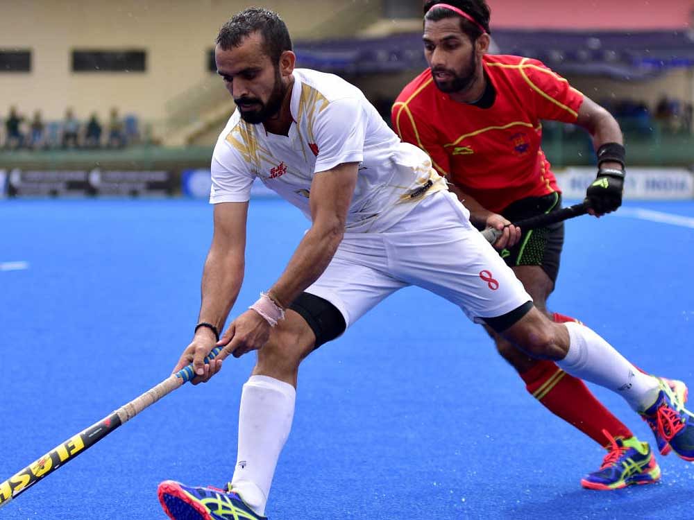 Jagwant Singh of ONGC (Right) and S Niyaz Rahim of South Central Railway vie for the ball, during their clash in the Bengaluru Super Division Hockey League-2017 at KSHA stadium in Bengaluru on Sunday.