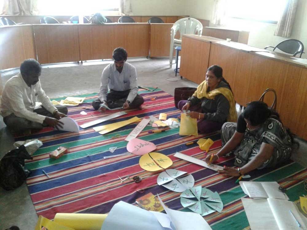 Teachers working together on visual learning aids as a part of the training conducted by RVCE in Bengaluru.