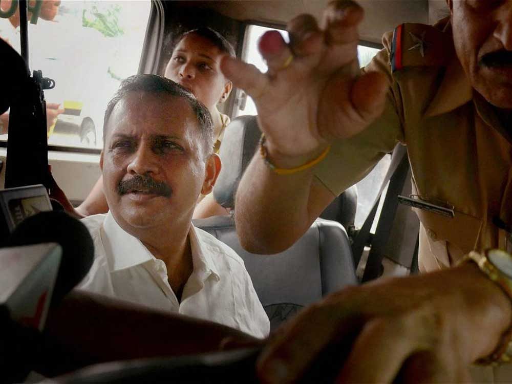 Lt Col Prasad Shrikant Purohit being escorted out of the Mumbai Sessions Court. DH Photo