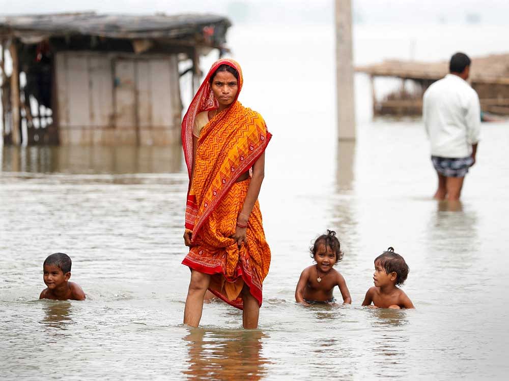 A woman walks through a flooded village in Motihari, Bihar State, India. Reuters Photo
