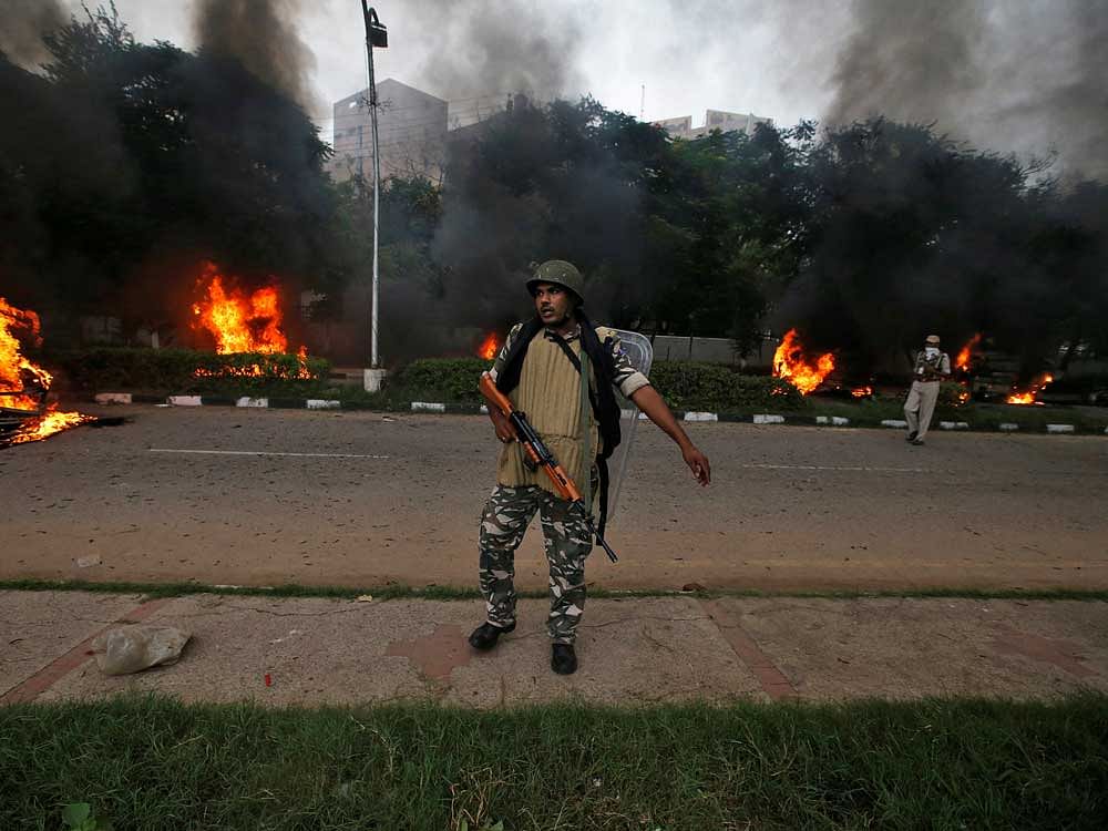 A member of the security forces reacts during violence in Panchkula, India. Reuters Photo