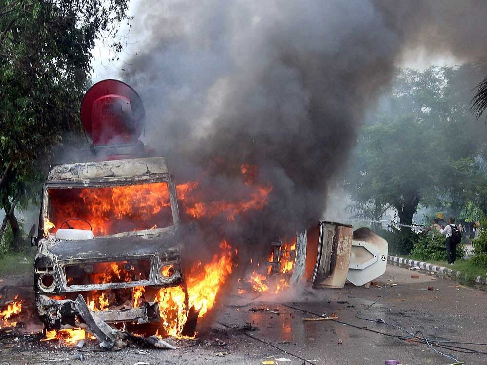 Vans of television media broadcaters burn in violence following Dera Sacha Sauda chief Gurmeet Ram Rahim's conviction in Panchkula on Friday. PTI Photo