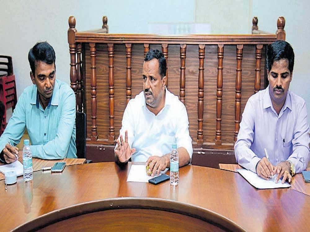 Minister f Kumor Food and Civil Supplies U T Khader speaks at a meeting in DC's office in Mangaluru on Saturday. Deputy Commissioner Dr K G Jagadeesha and Additional Deputy Commissioner Kumar look on.