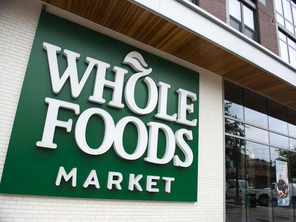 This file photo taken on June 16, 2017 shows a Whole Foods Market sign in Washington, DC. Amazon announced on August 24, 2017 that its takeover of Whole Foods Market will close next week, as it vowed to cut grocery prices and fully integrate the chain into its retail empire.