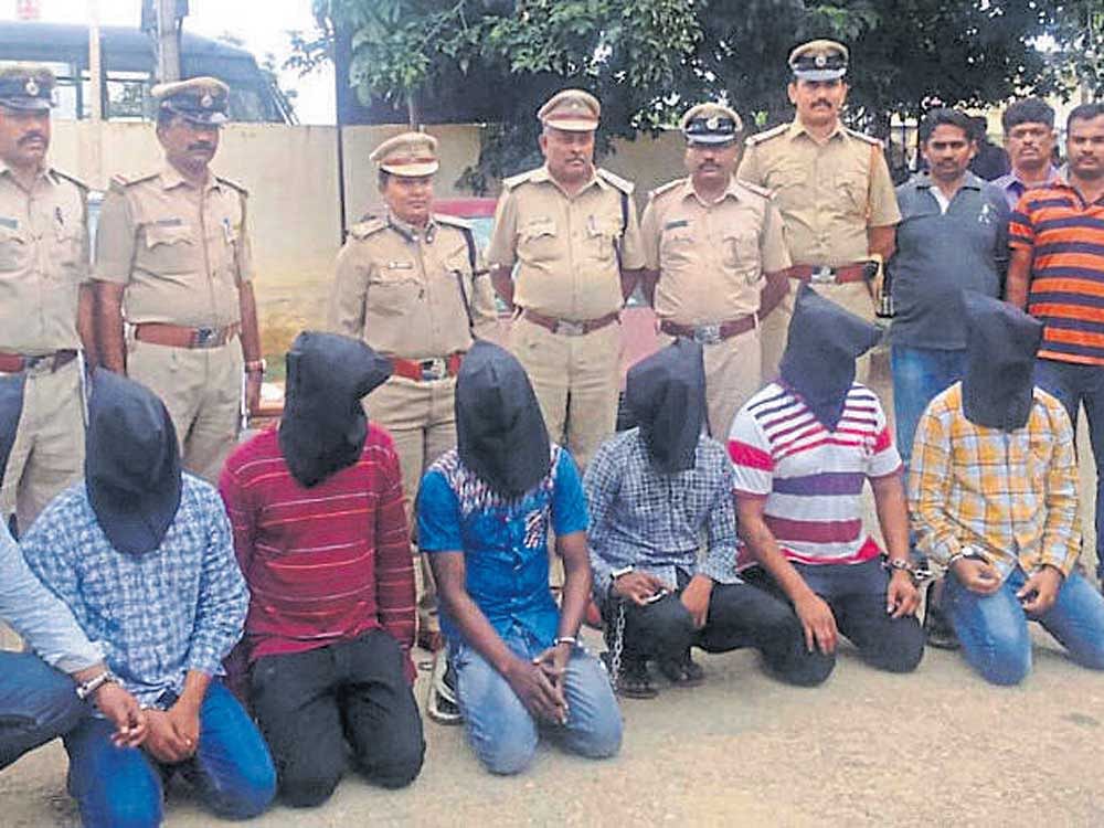 Superintendent of Police G Radhika, DySP P Chandrashekar and other personnel seen with the accused in the murder of a rowdy sheeter, at Nagamangala taluk, Mandya district. DH photo