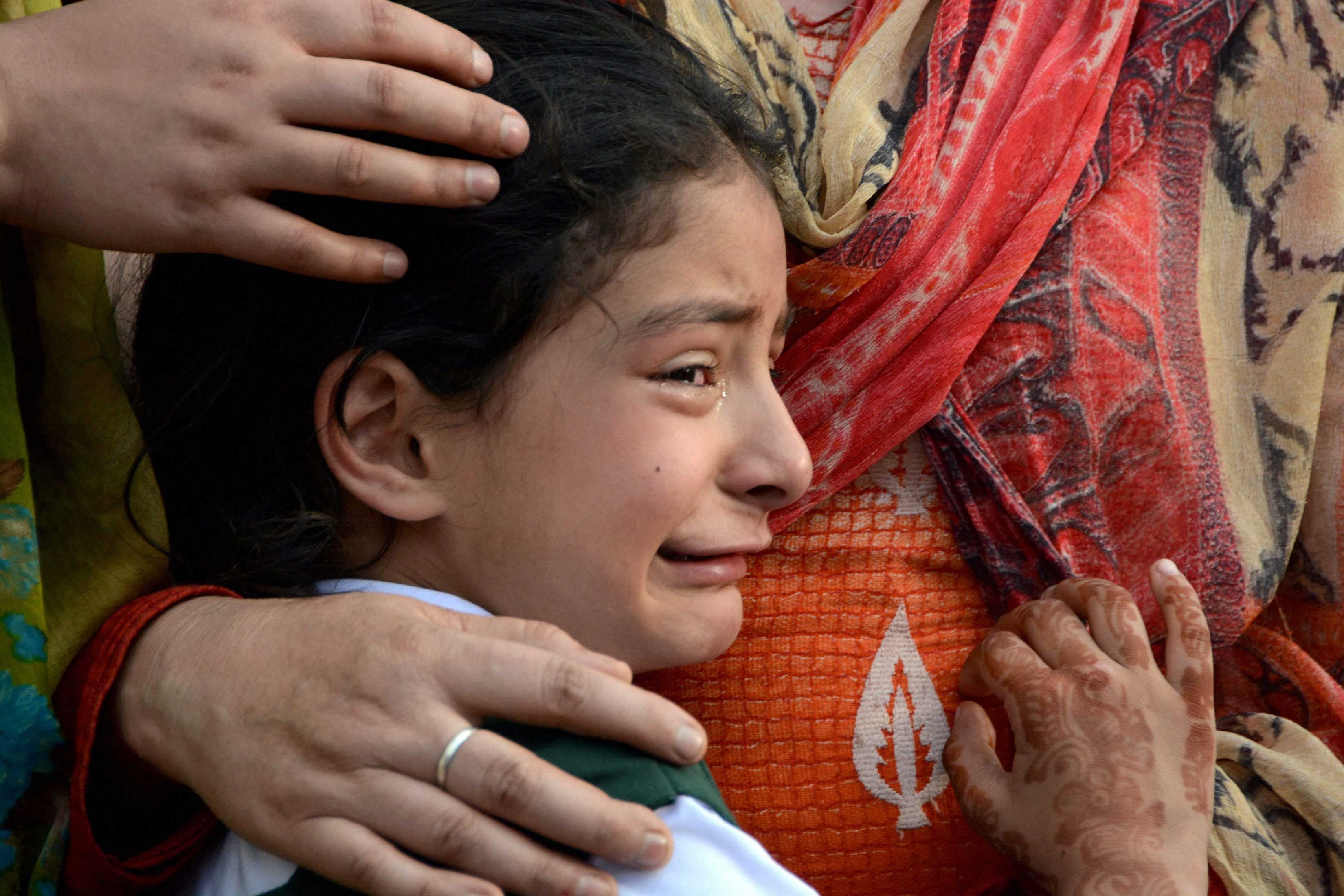 Seven-Year old Zohra, daughter of police officer ASI Abdul Rashid who was shot dead by militants in an attack on police party in Anantnag, crying while watching wreath laying ceremony, in Srinagar on Monday. PTI Photo