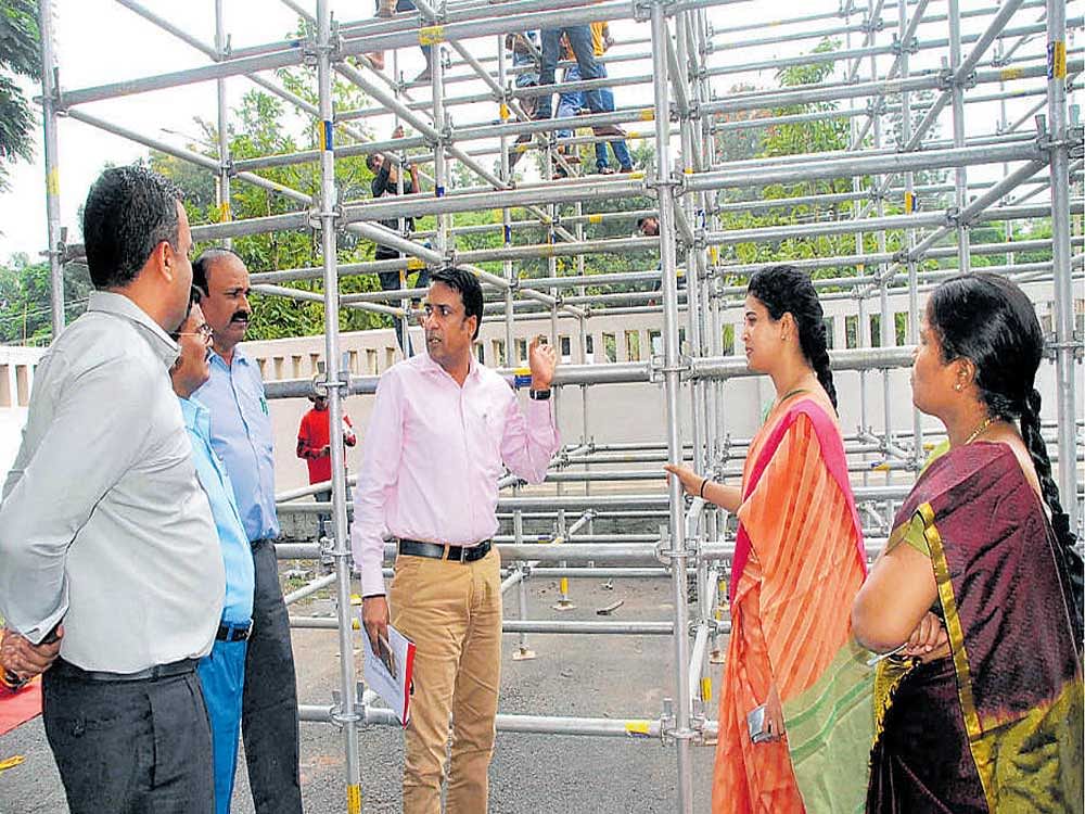 District in-charge Secretary Naveen Raj Singh, Deputy Commissioner Rohini Sindhuri and Special Officer Varaprasad Reddy inspect the demo of the attic proposed to be created during the Bahubali Mahamastakabhisheka Mahotsava, at the DC's office, in Hassan on Tuesday.