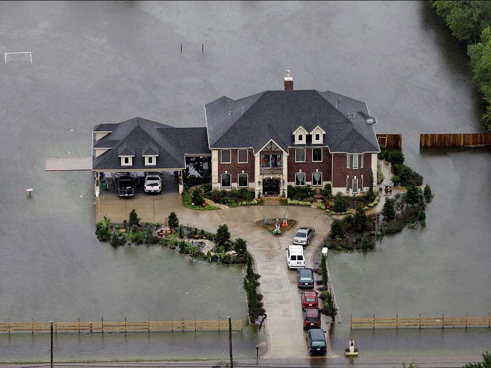 A home is surrounded by floodwaters from Tropical Storm Harvey on Tuesday, Aug. 29, 2017, in Houston. AP/PTI