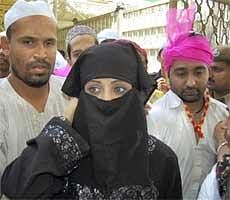 Rajasthan Royals' co-owner Shilpa Shetty (wearing burqa) with her husband Raj Kundra (R) and Cricketer Yusuf Pathan at the the shrine of Khwaja Moinuddin Chishty in Ajmer on Saturday. PTI