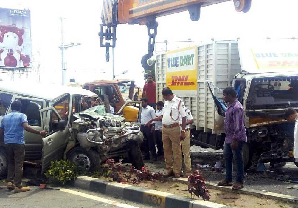 The mangled remains of the SUV and the trucks which were involved in an accident on the airport road near Chikkajala. Three people were killed and six injured when the SUV jumped the median after losing control and collided with a courier vehicle, which in turn was hit by another truck from behind. DH Photo