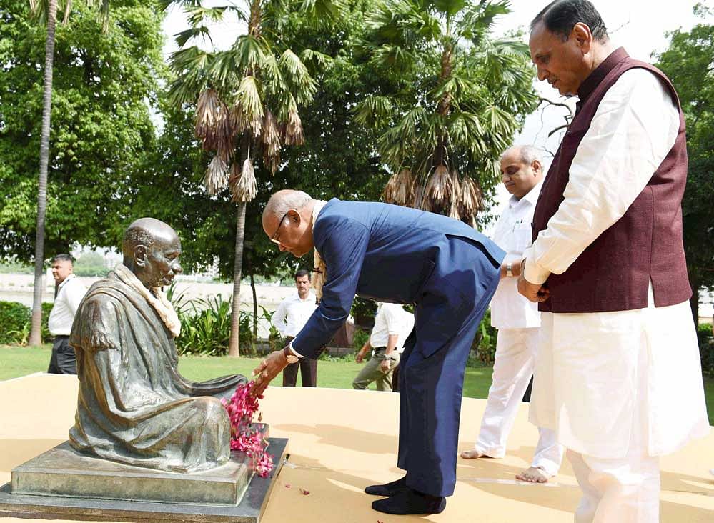 President Ramnath Kovind, along with Gujarat Chief Minister Vijay Rupani, paying homage at a statue of Mahatma Gandhi during his visit to Gandhi Ashram in Ahmedabad on Sunday. PTI Photo