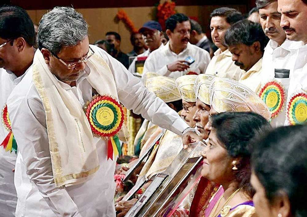 Karnataka Chief Minister Siddaramaiah presents state awards for best teachers during the 'Teachers' Day' celebration, at Ambedkar Bhavan, in Bangalore. PTI photo.