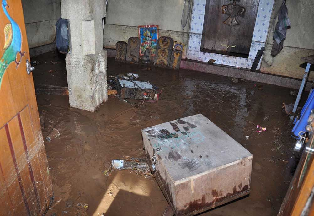 Rainwater entered Anjaneya temple at Kollegal. (Right) Houses were inundated due to heavy rain that lashed Kollegal in Chamarajanagar district.