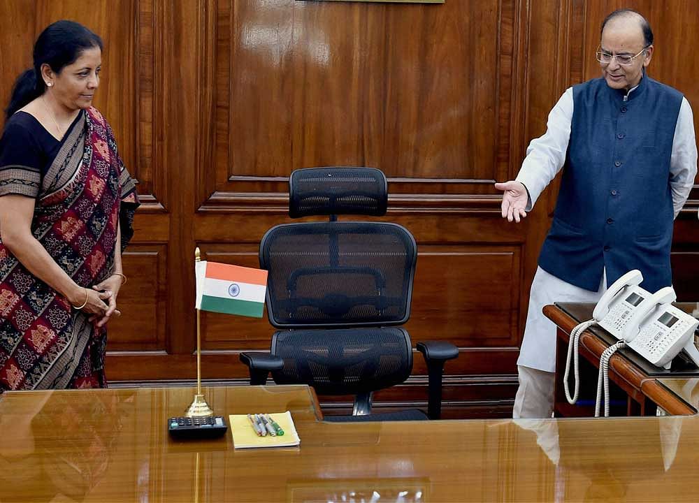 Outgoing Defence Minister Arun Jaitley gestures to new Defence Minister Nirmala Sitharaman as she takes charge at her office at South Block in New Delhi on Thursday. PTI Photo