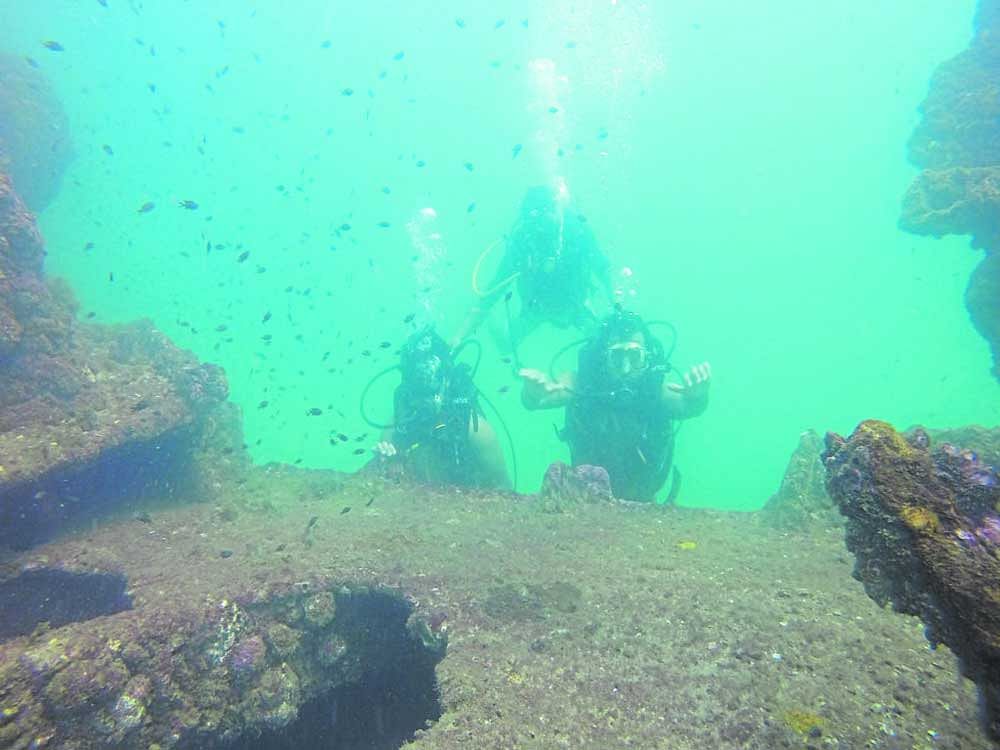 Two scuba divers with an instructor at the dive center around Goa.