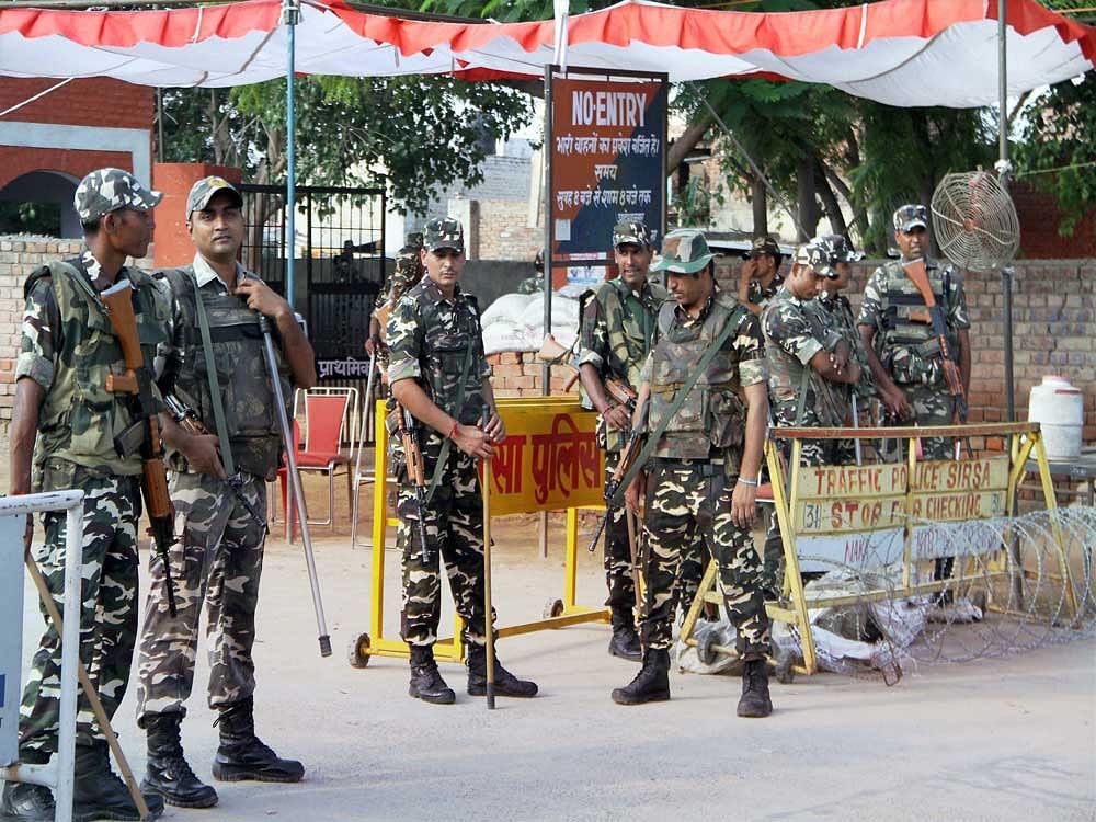 Security forces personnel stand guard during the third day of search operation at the Dera Sacha Sauda ashram in Sirsa on Sunday. PTI Photo