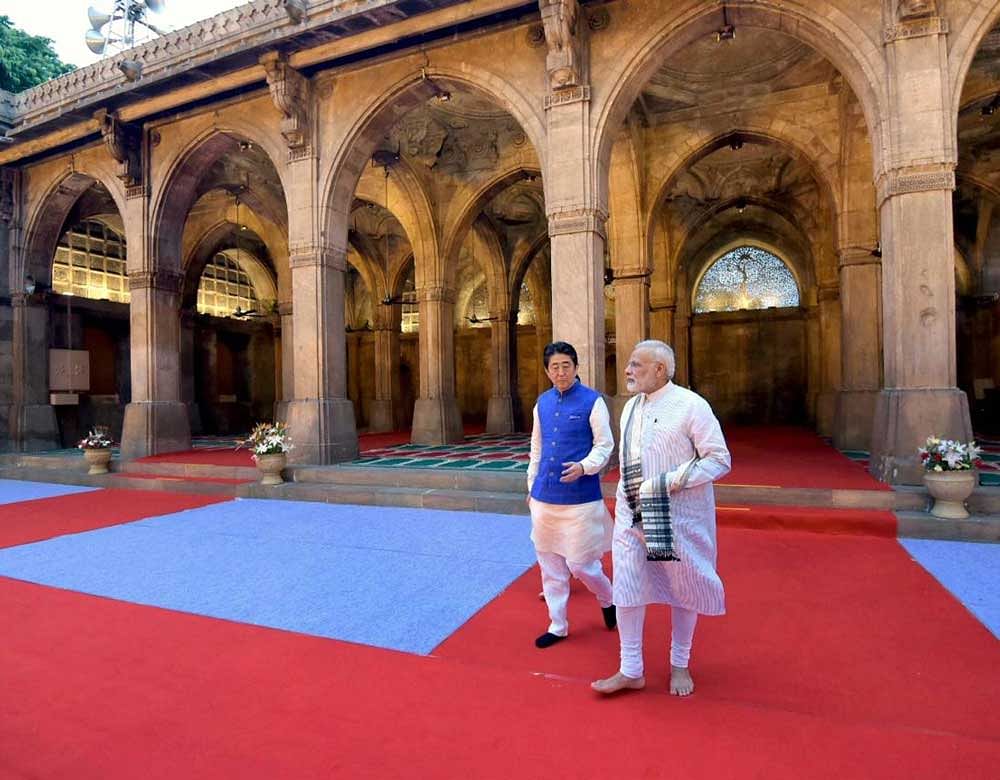 Prime Minister Narendra Modi and Japanese Prime Minister Shinzo Abe during a visit to the Sidi Saiyyed Mosque in Ahmedabad on Wednesday. PTI Photo / PIB