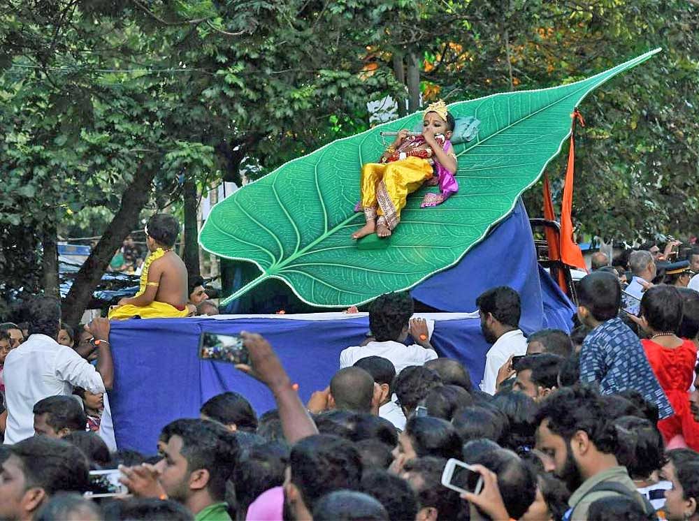 The boy was tied at the waist to a slanting peepal leaf replica during the procession in Payyannur, Kannur, on Tuesday. PTI