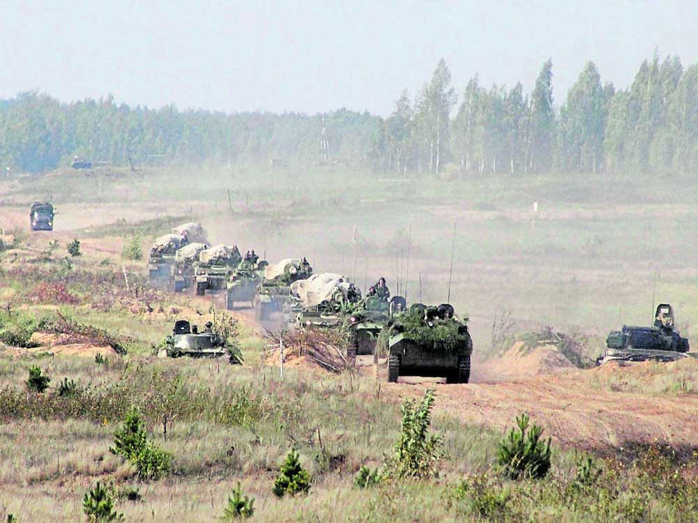 on high alert: A military convoy arrives at a training ground at an undisclosed location in Belarus on Monday. The Zapad (West) 2017 manoeuvres, have caused major concern at NATO and in neighbouring countries. AP/PTI