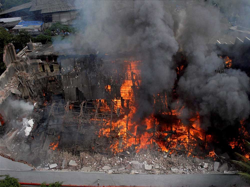Smoke rises from a burning section of the RK Studio after it caught fire, in Mumbai on Saturday. PTI photo