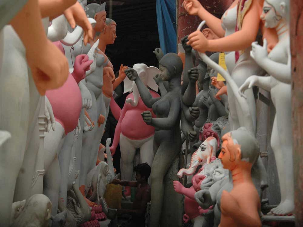 An idol maker gives final touches at Kumartuli, the traditional idol-making hub in Kolkata. Debasish Bhaduri