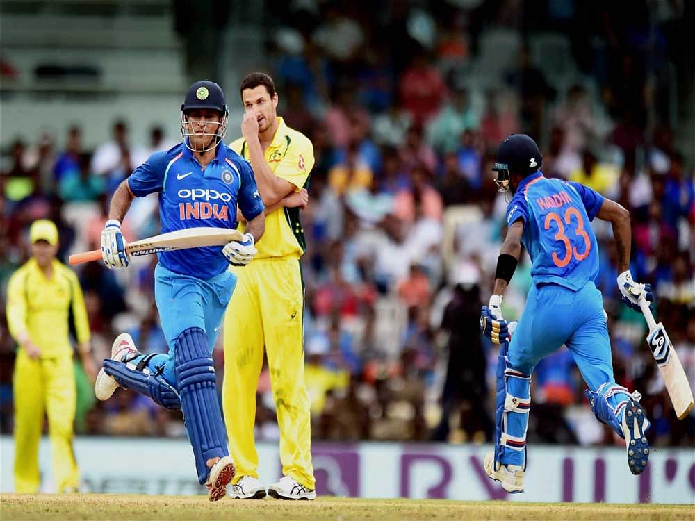 India's MS Dhoni and Hardik Pandya run between the wickets during the first India-Australia One Day International (ODI) cricket match being played at the M A Chidhambaram stadium in Chennai on Sunday. PTI Photo