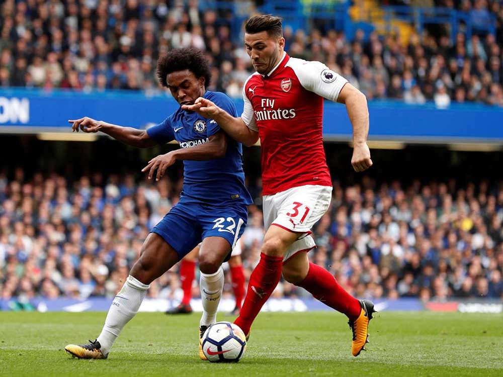 Chelsea's Willian (left) and Arsenal's Sead Kolasinac vie for the ball on Sunday.