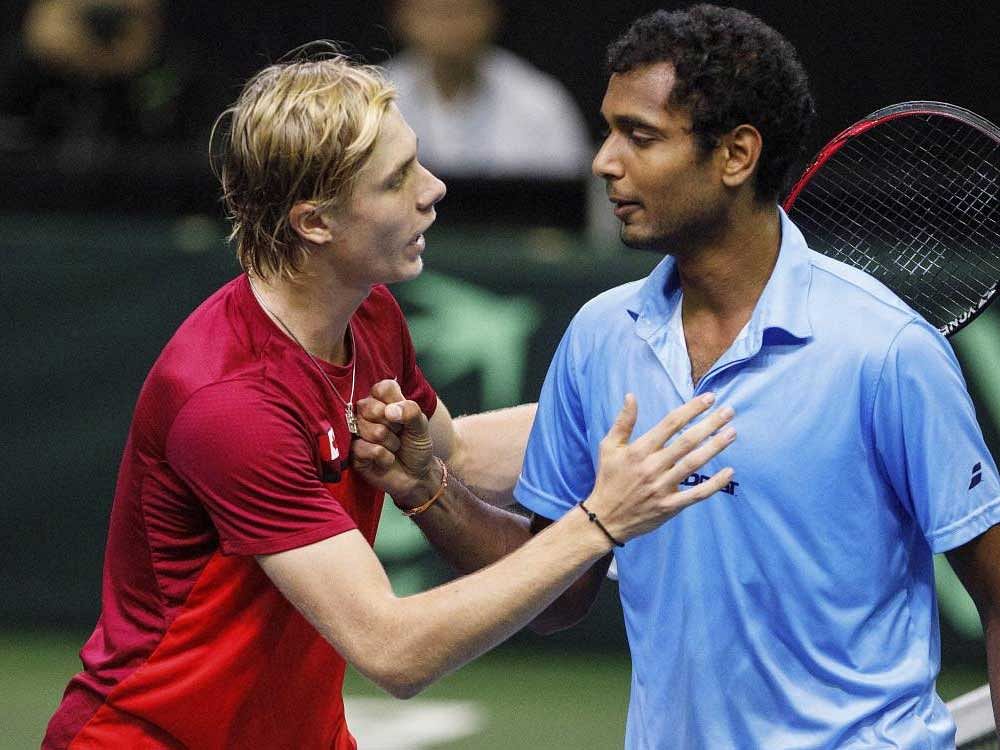 Canada's Denis Shapovalov (left) is congratulated by India's Ramkumar Ramanathan after their Davis Cup match in Edmonton on Sunday. Canada defeated India 3-2 to secure a place in the World Group. AP/ PTI