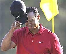 Tiger Woods tips his cap on the 18th green after finishing his final round of the Masters golf tournament in Augusta on Sunday. AP