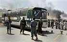 misfire: Afghan policemen and anti-American protesters stand near a bus after it was fired upon by international troops in Kandahar on Monday. AP