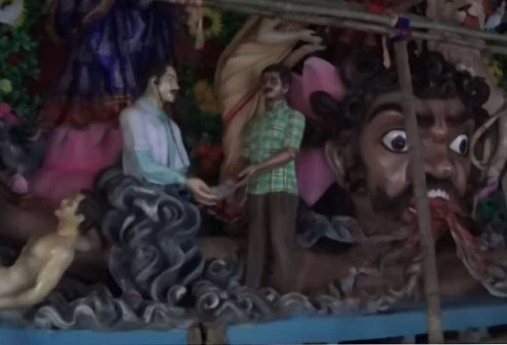 The clay model showing a doctor taking money from a person in Mohammed Ali Park's Durga Puja pandal. Twitter photo.