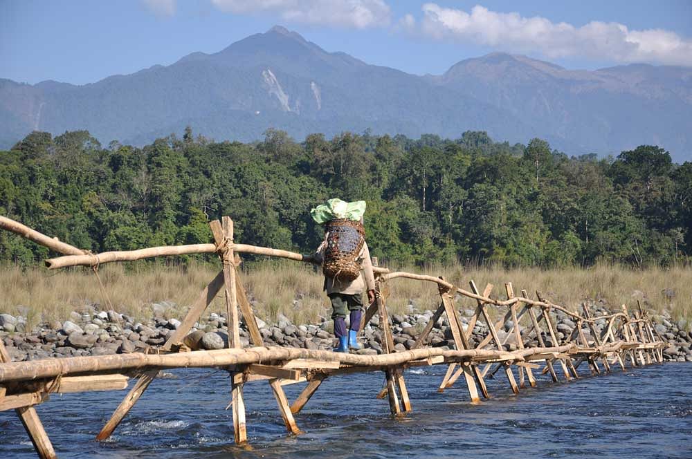 File photo of a Chakma tribal crossing a bridge. The Chakma and Hojang people have longed for rights, according to Mahendra Singh, in a letter to Rajnath Singh.