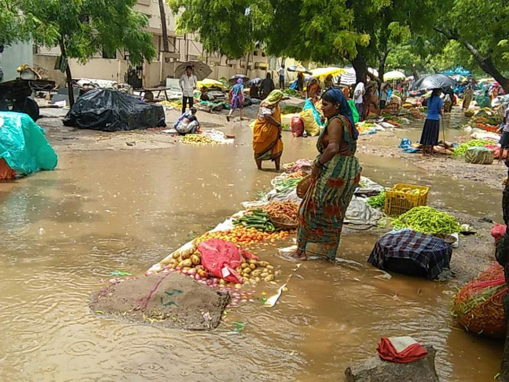 Vegetables and other items on sale at the weekly fair were damaged due to heavy rain at Maski in Raichur district.  DH Photo