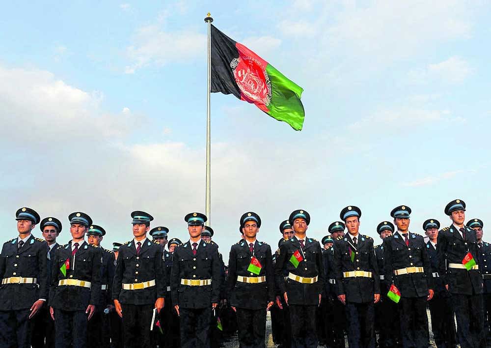 Deep connections: Afghan soldiers marching near their national flag in Kabul which was raised by former President Hamid Karzai and External Affairs Minister Sushma Swaraj in 2014. AFP