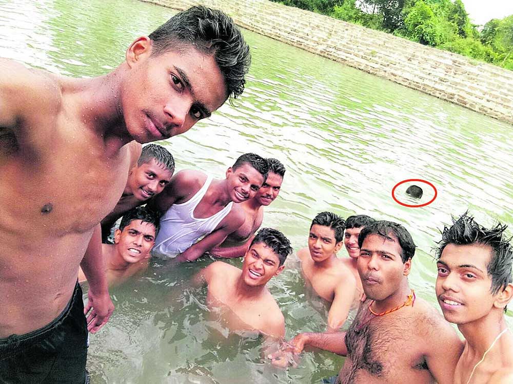 The students take a selfie as Vishwas (circled) drowns in the water in Ravugodlu in Bengaluru South taluk. DH photo