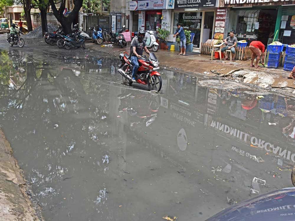 Sewage-filled rainwater flooded 11th Main, 80 Feet Road Cross, 4th Block, Koramangala, on Monday following the all-night rainfall in the city. DH PHOTOS/S K Dinesh