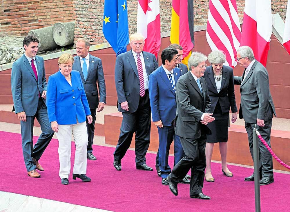de facto leader: Germany's Chancellor Angela Merkel with other leaders at the Group of 7 summit meeting earlier this year. She regularly jousts with US President Donald Trump over trade and climate, with President Vladimir V Putin of Russia over Crimea and with President Recep Tayyip Erdogan of Turkey over human rights. NYT