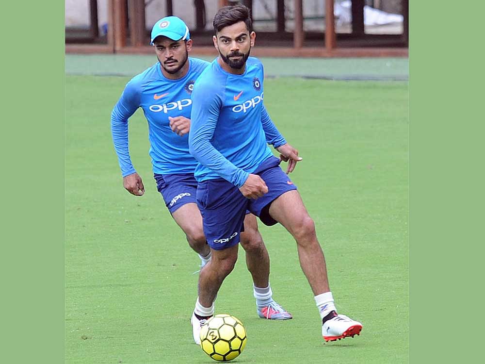 competitive: Captain Virat Kolhi (right) and Manish Pandey warm-up with a round of football before India's practice on Tuesday. DH photo/ Srikanta Sharma R