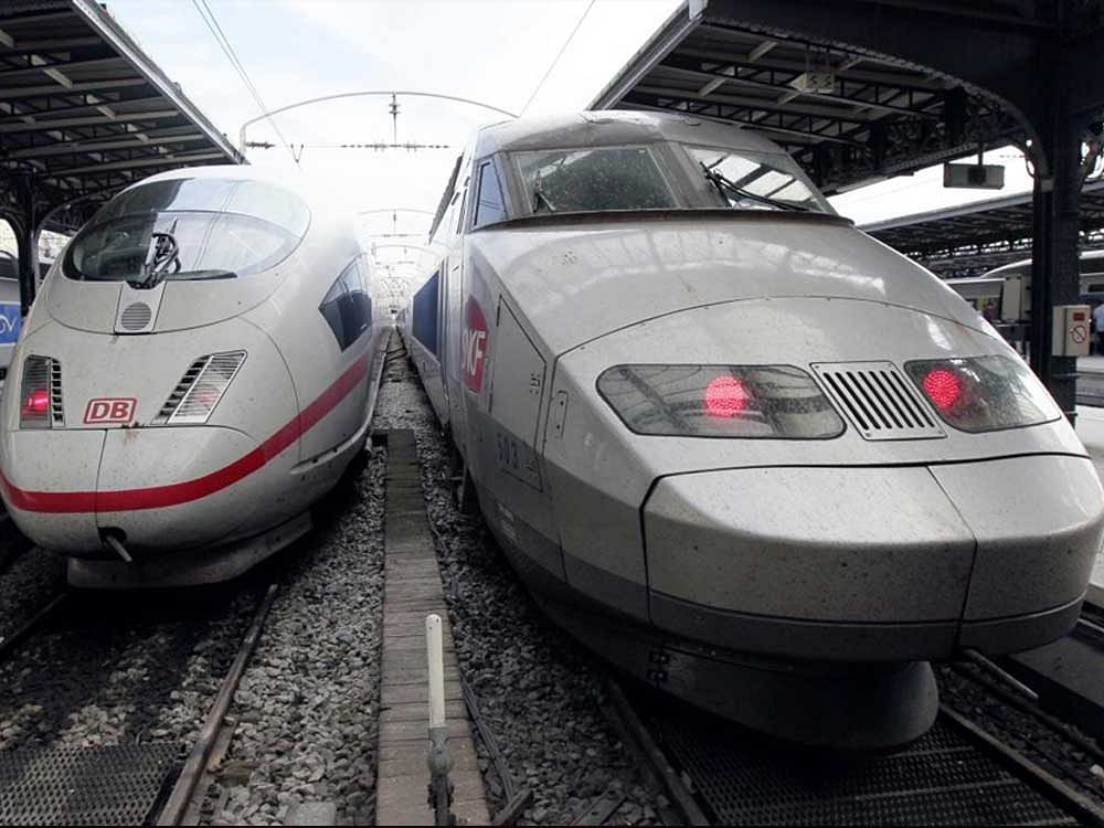 This file photo shows two high-speed trains, a German railway Deutsche Bahn ICE (L) and a French railway SNCF TGV on a platform in Paris. The French government defended allowing train maker Alstom to be swallowed by its German rival  Siemens as it came under attack from opponents for failing to protect a domestic industrial giant. AFP