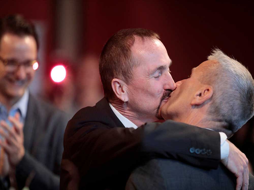 Same-sex couple Karl Kreil and Bodo Mende get married at a civil registry office, becoming Germany's first married gay couple after German parliament approved marriage equality in a historic vote this past summer, in Berlin, Germany October 1, 2017. REUTERS/Axel Schmidt