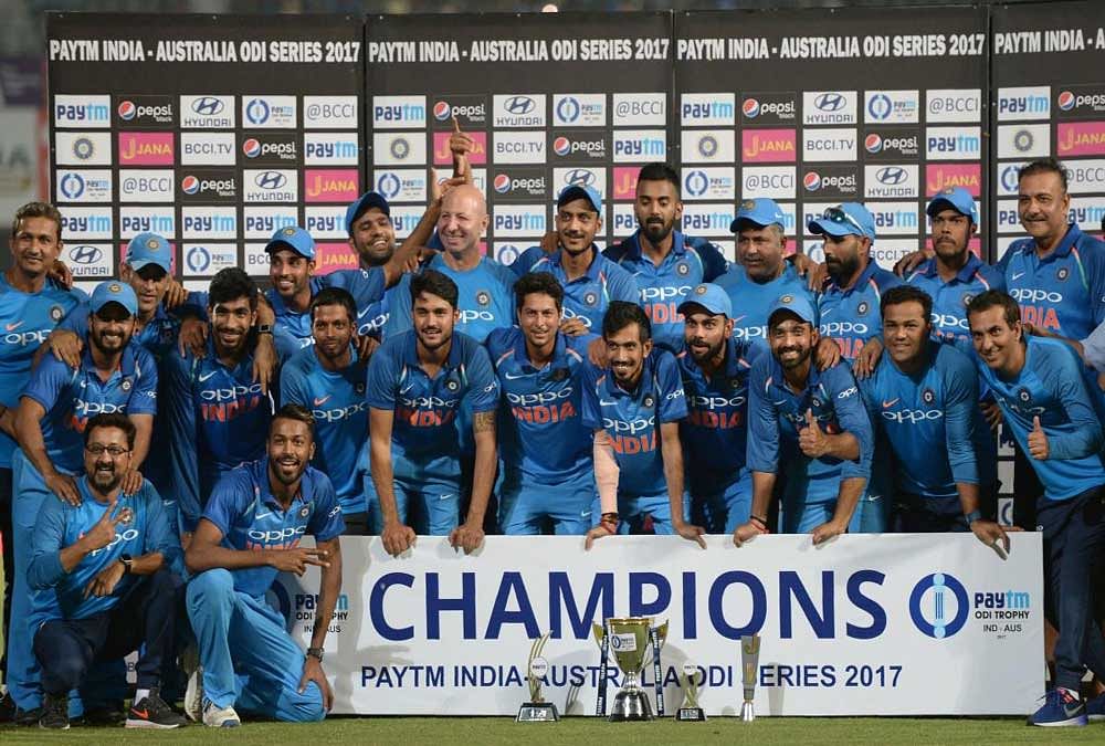 Emphatic win: Indian players pose with the trophy after winning the fifth one-day international against Australia in Nagpur on Sunday. AFP