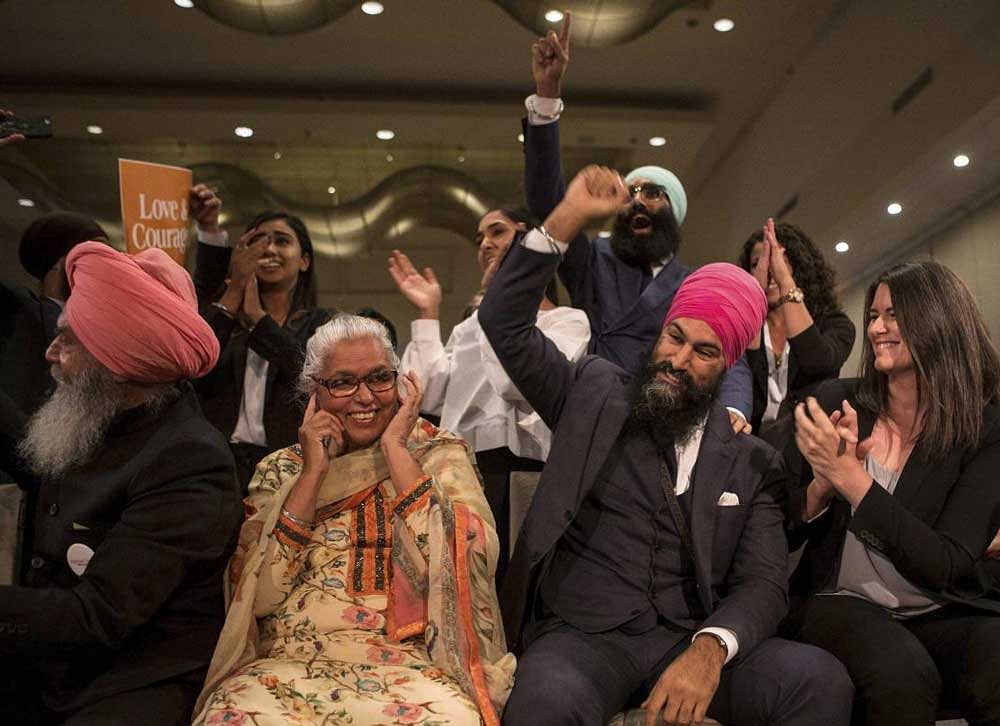 Jagmeet Singh, center right, sits with his mother Harmeet Kaur, center left, father Jagtaran Singh, left, and campaign manager Michal Hay, right, as it's announced he has won the first ballot in the contest for leader of the leftist New Democrat party in Toronto on Sunday, Oct. 1, 2017. The former lawyer will have an uphill battle when he challenges Canadian Prime Minister Justin Trudeau's governing Liberal Party in the next election. Singh's party has just 44 of the 338 seats in Parliament. AP/PTI